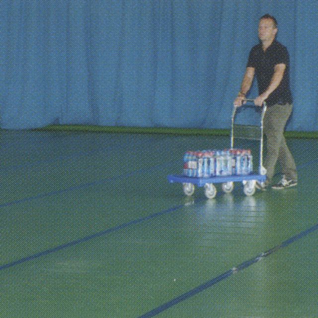 Green sports floor protection laid and taped in a sports hall